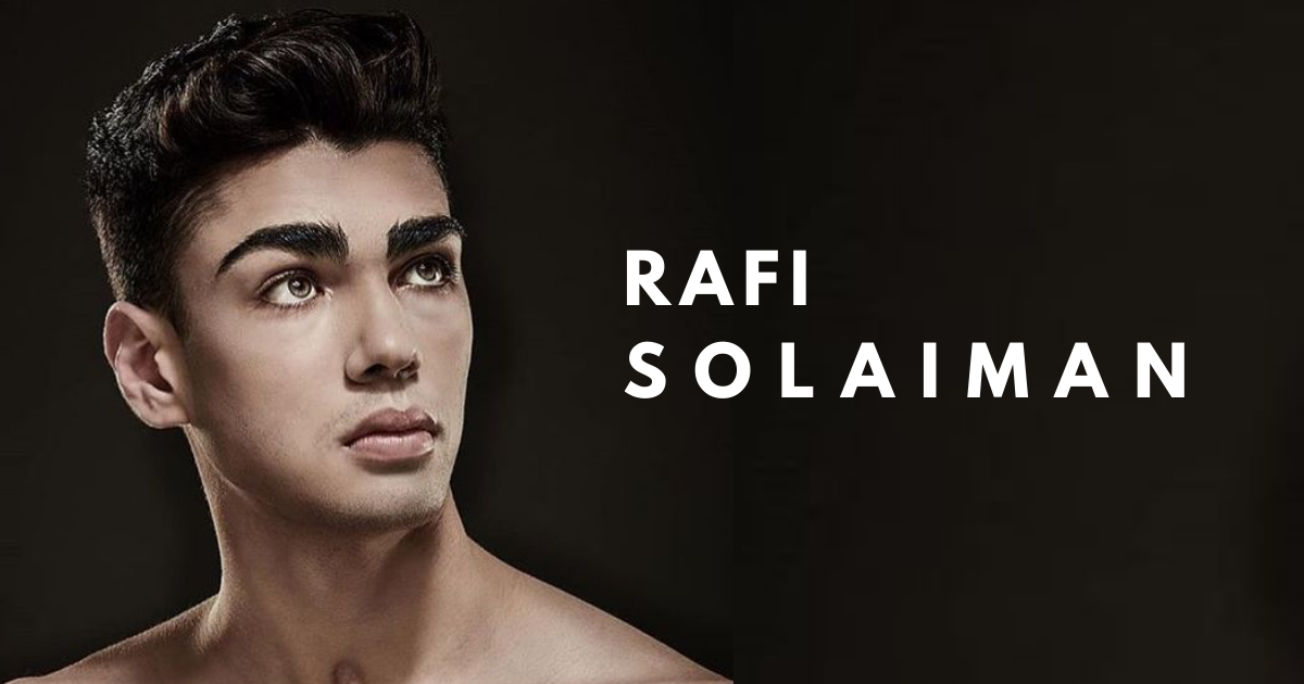 A close up portrait of Rafi, a young man with olive skin, green eyes.
